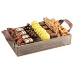 Gourmet chocolates, sweets, and roasted and candied nuts on a wooden tray from shiva.com. Kosher