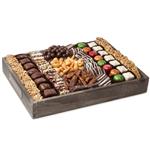 Assorted chocolates and roasted and candied nuts on a wooden tray from shiva.com. Kosher